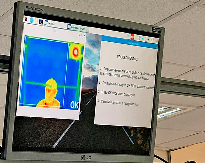 audiodescrição: fotografia colorida de um monitor onde aparece a imagem térmica de uma pessoa