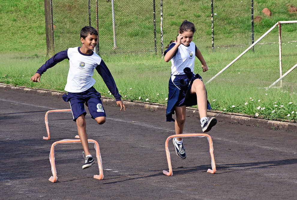 Crianças que contato com equipamento de atletismo pela primeira vez