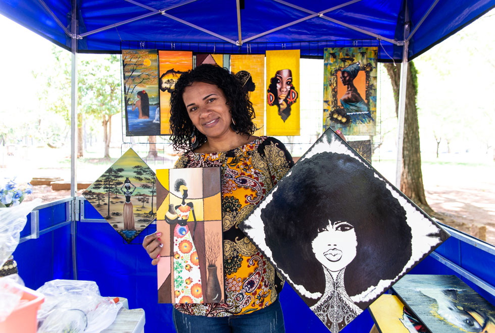 A artista Sandra Guedes expõe seus quadros com desenhos alusivos à cultura afro-brasileira
