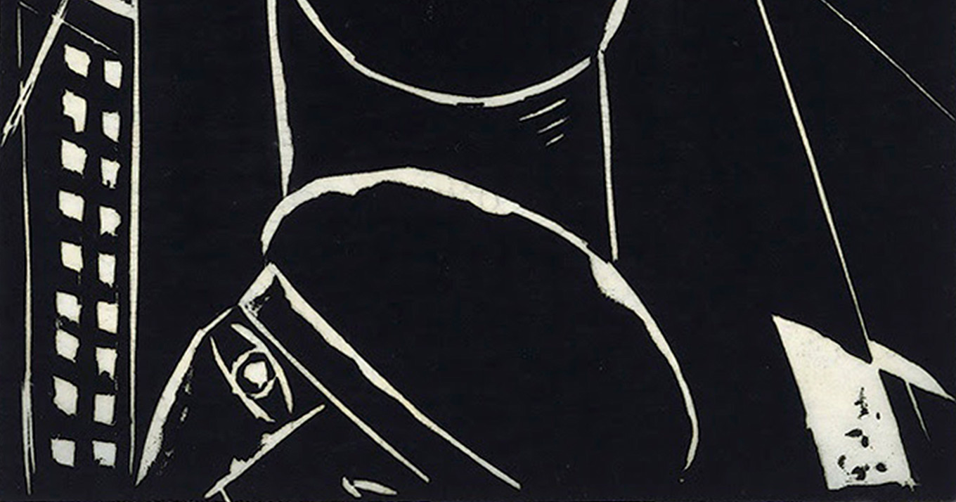 Detalhe de uma xilogravura em que aparece a cabeça de um homem em fundo preto.