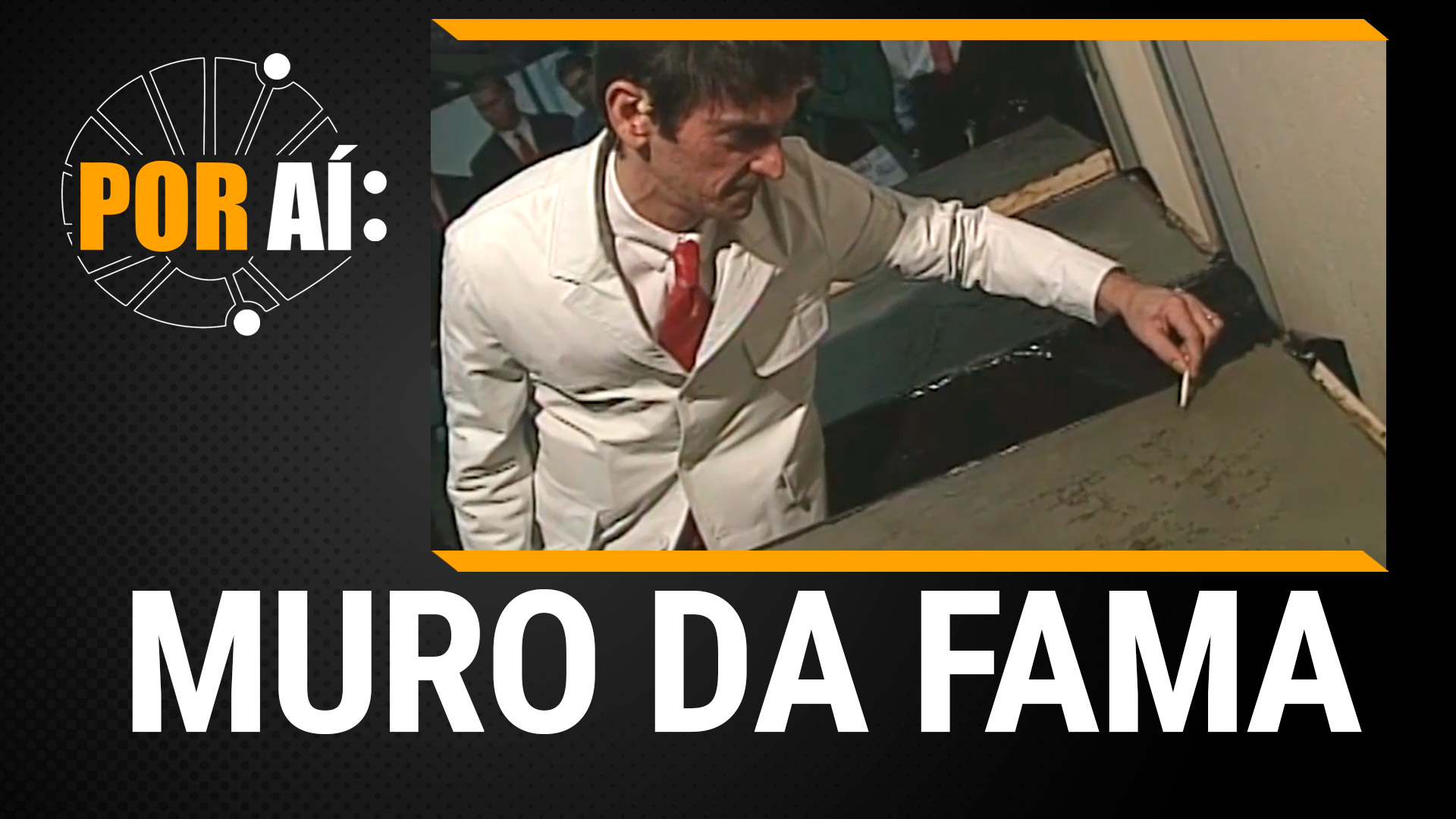 imagem homem desenhando em placa de concreto com legenda muro da fama