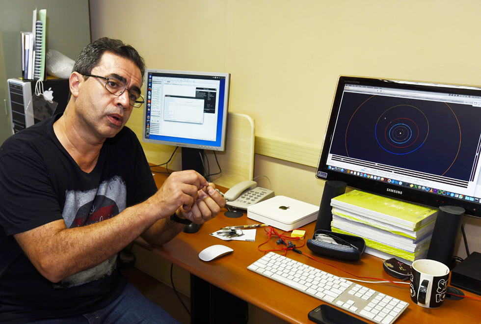 Professor Samuel Rocha de Oliveira, do Instituto de Matemática, Estatística e Computação Científica (IMECC) da Unicamp A galeria traz o professor Samuel Rocha de Oliveira, do Instituto de Matemática, Estatística e Computação Científica. Para acessá-la, tecle enter. Audiodescrição: Em sala, imagem em perfil e plano médio, homem sentado em cadeira, à esquerda na imagem, fala enquanto gesticula com as mãos, mantendo os braços para frente e as mãos fechadas e unidas. À frente dele, um monitor de computador que encontra-se sobre uma mesa de madeira, à direita. Ele usa óculos e veste camisa de mangas curtas preta. Imagem 1 de 3.