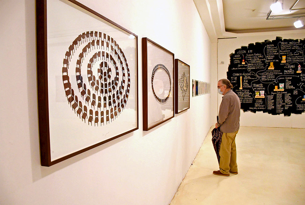 Imagem de exposição de arte que mostra três quadros em estilo abstrato