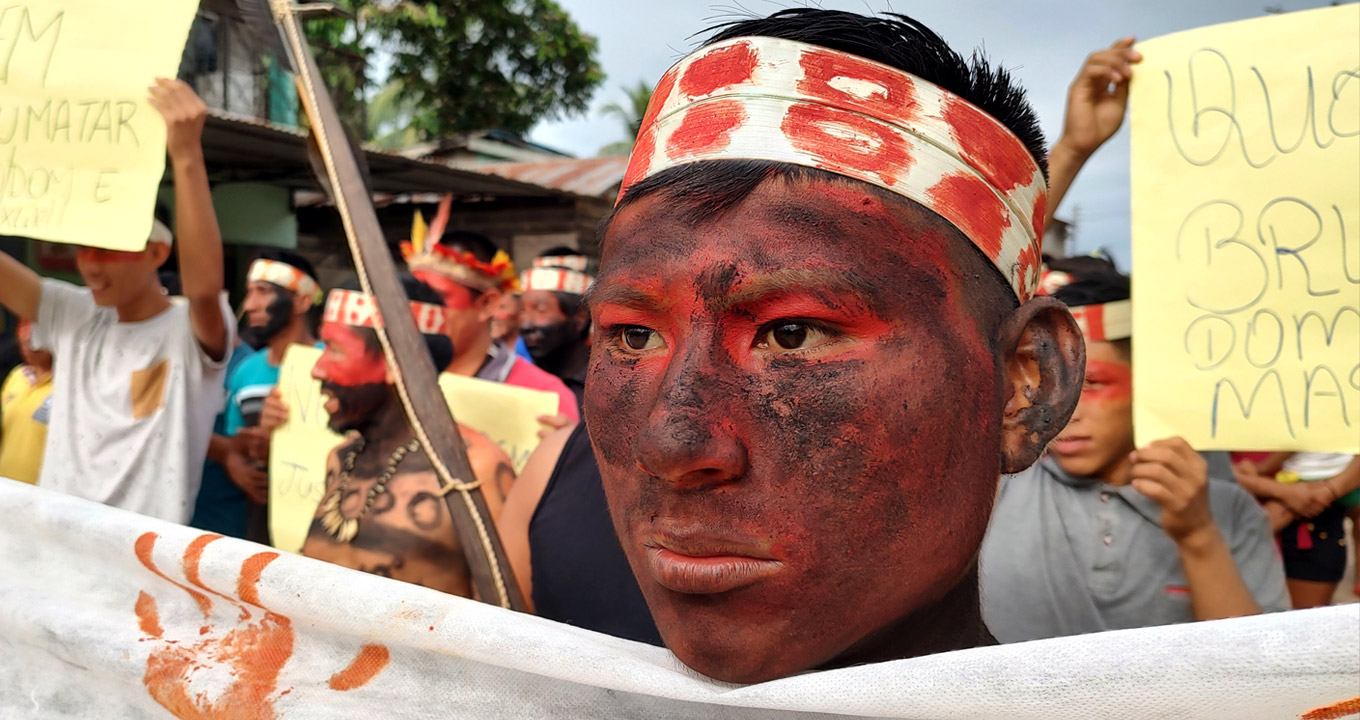 audiodescrição: fotografia colorida de indígenas em uma manifestação